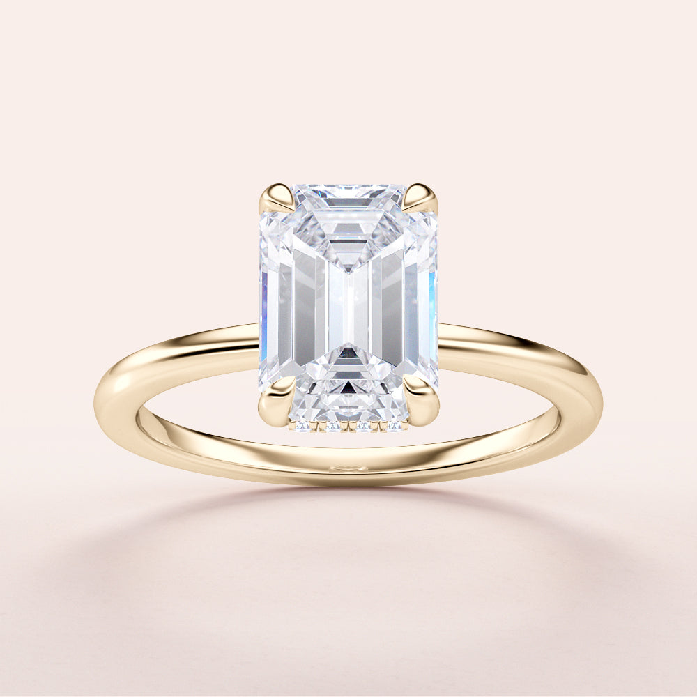 Elegant yellow gold emerald-cut diamond engagement ring, available in 14K, 18K, or platinum, showcasing timeless beauty.