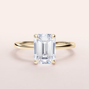 Elegant emerald-cut diamond engagement ring with a yellow gold band, available in 14K or 18K options.