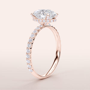 Elegant rose gold engagement ring with marquise diamond center and halo, adorned with additional diamonds. Available in 14K, 18K, or platinum.