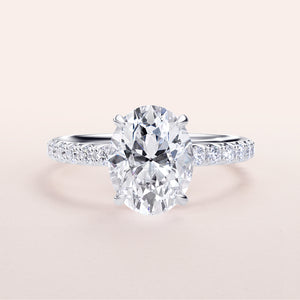Elegant oval diamond engagement ring with a pave band in 14K, 18K gold or platinum, showcasing hidden halo and prong accents.