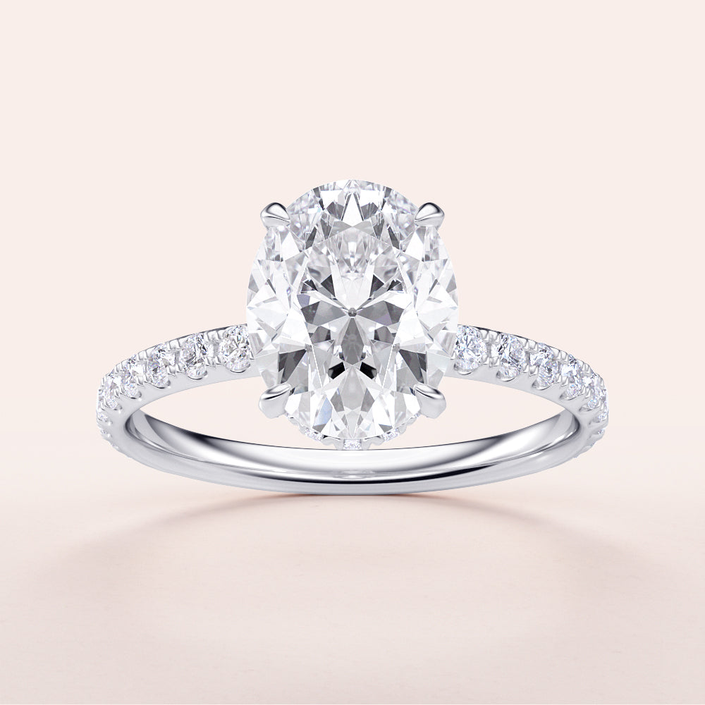 Elegant oval diamond engagement ring in 14K or 18K gold or platinum with a delicate pave band, set against a light background.|

#14KRecycledWhiteGold
#18KRecycledWhiteGold








#Platinum