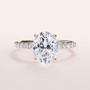 Elegant oval diamond engagement ring in 14K gold, set in a pave band, showcasing a hidden halo and stunning prong accents.