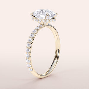 14K yellow gold engagement ring featuring an oval wrapped hidden halo, prong accents, and pave-set diamond band, side view.

#14KRecycledYellowGold
#18KRecycledYellowGold


