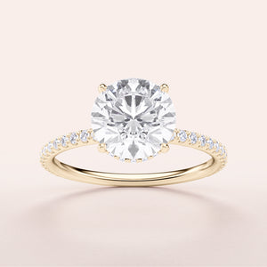 Elegant 14K yellow gold engagement ring with round brilliant diamond, set in aPave band for a timeless statement.