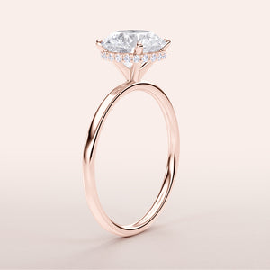 Elegant marquise diamond ring in 14K rose gold with pave diamond halo, close-up view. Also available in 18K and platinum.