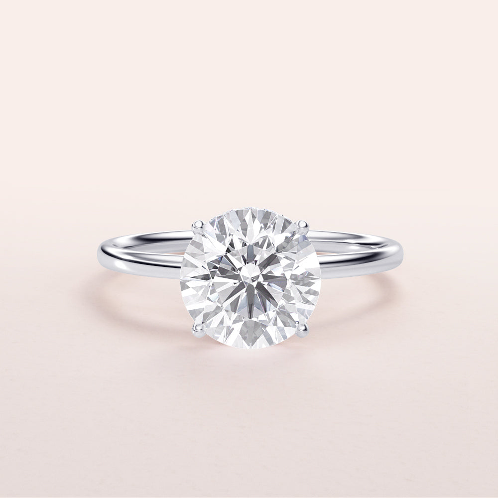 Solitaire round brilliant-cut diamond engagement ring in 14K white gold with a sleek band design, perfect for timeless elegance.