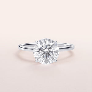 Solitaire round brilliant-cut diamond engagement ring in 14K white gold with a sleek band design, perfect for timeless elegance.