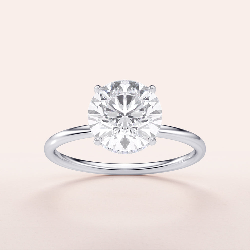 Elegant 14K or 18K white gold round-wrapped hidden halo engagement ring, featuring a stunning round-cut diamond.