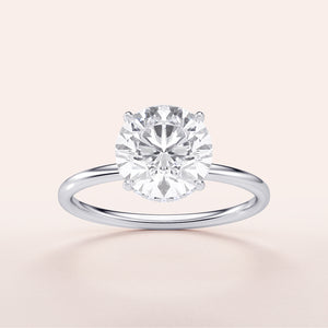 Elegant 14K or 18K white gold round-wrapped hidden halo engagement ring, featuring a stunning round-cut diamond.