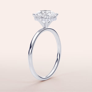 14K/18K white gold engagement ring featuring a marquise-cut diamond with a halo of smaller diamonds on a neutral background.
