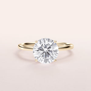 Elegant 14K yellow gold engagement ring featuring a round brilliant-cut diamond in a wrapped hidden halo design.