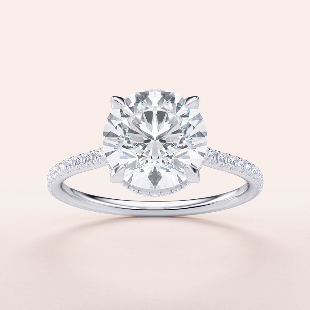 Round diamond engagement ring in 14K or 18K white gold, featuring a delicate pave band and a hidden halo design.|

#14KRecycledWhiteGold
#18KRecycledWhiteGold








#Platinum