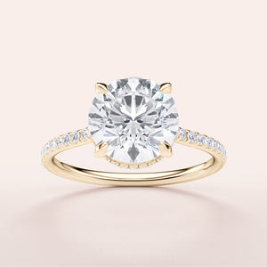 14K gold engagement ring featuring a round brilliant diamond center stone with a delicatePave diamond band, showcasing timeless elegance.