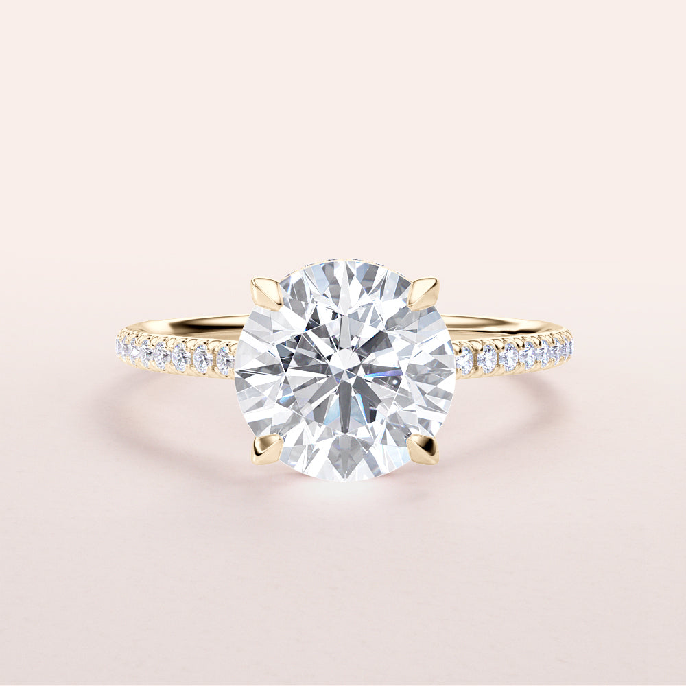 Elegant yellow gold engagement ring with round brilliant-cut diamond and smaller diamonds, available in 14K and 18K options.|




#14KRecycledYellowGold
#18KRecycledYellowGold





