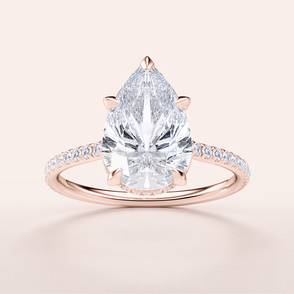 Elegant pear-shaped diamond engagement ring in 14K rose gold, featuring a stunning diamond-studded pave band.|







#14KRecycledRoseGold
#18KRecycledRoseGold



