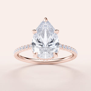 Elegant pear-shaped diamond engagement ring in 14K rose gold, featuring a stunning diamond-studded pave band.