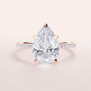 Elegant pear-shaped diamond engagement ring in rose gold, featuring a dazzling hidden halo and pave band, available in 14K & 18K.