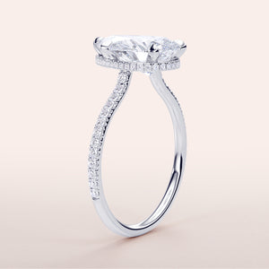 Elegant 14K white gold pear-shaped engagement ring withPave accents, showcasing a stunning diamond in an invisible gallery setting.