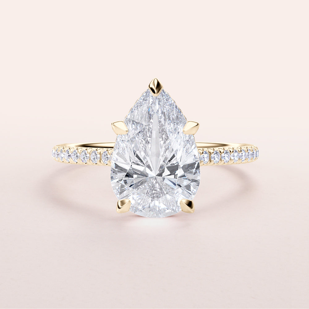 Elegant yellow gold pear-shaped diamond engagement ring in 14K or 18K, featuring a hidden halo and pave band for timeless beauty.|




#14KRecycledYellowGold
#18KRecycledYellowGold





