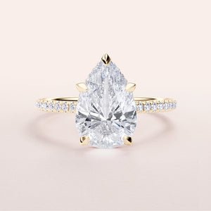 Elegant yellow gold pear-shaped diamond engagement ring in 14K or 18K, featuring a hidden halo and pave band for timeless beauty.