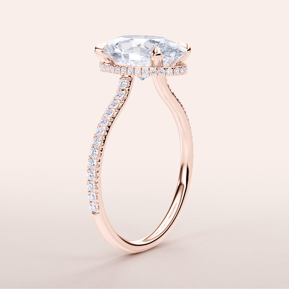 Elegant 14K rose gold engagement ring featuring a cushion-cut diamond on a pave band, designed for timeless beauty and sophistication.