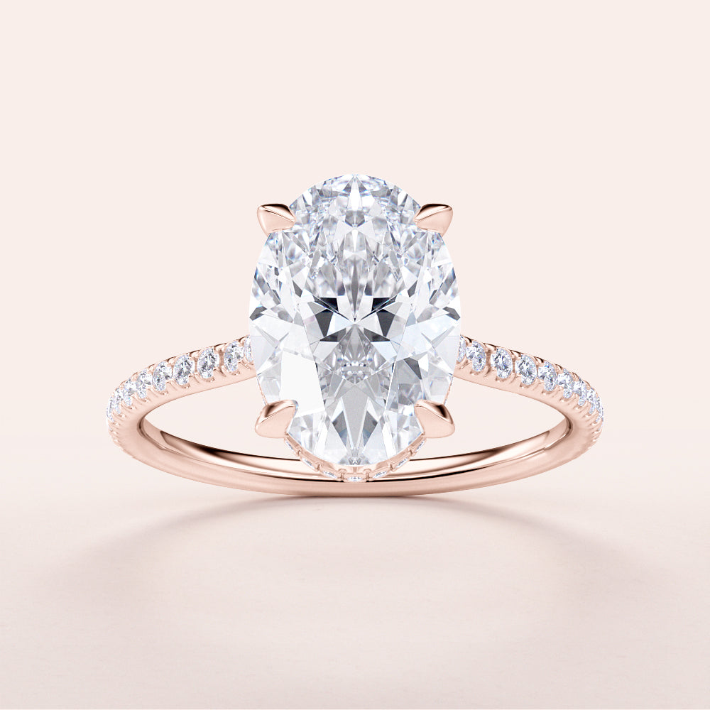 Elegant 14K Rose Gold oval diamond engagement ring with a halo pave band and sparkling center stone, perfect for any occasion.