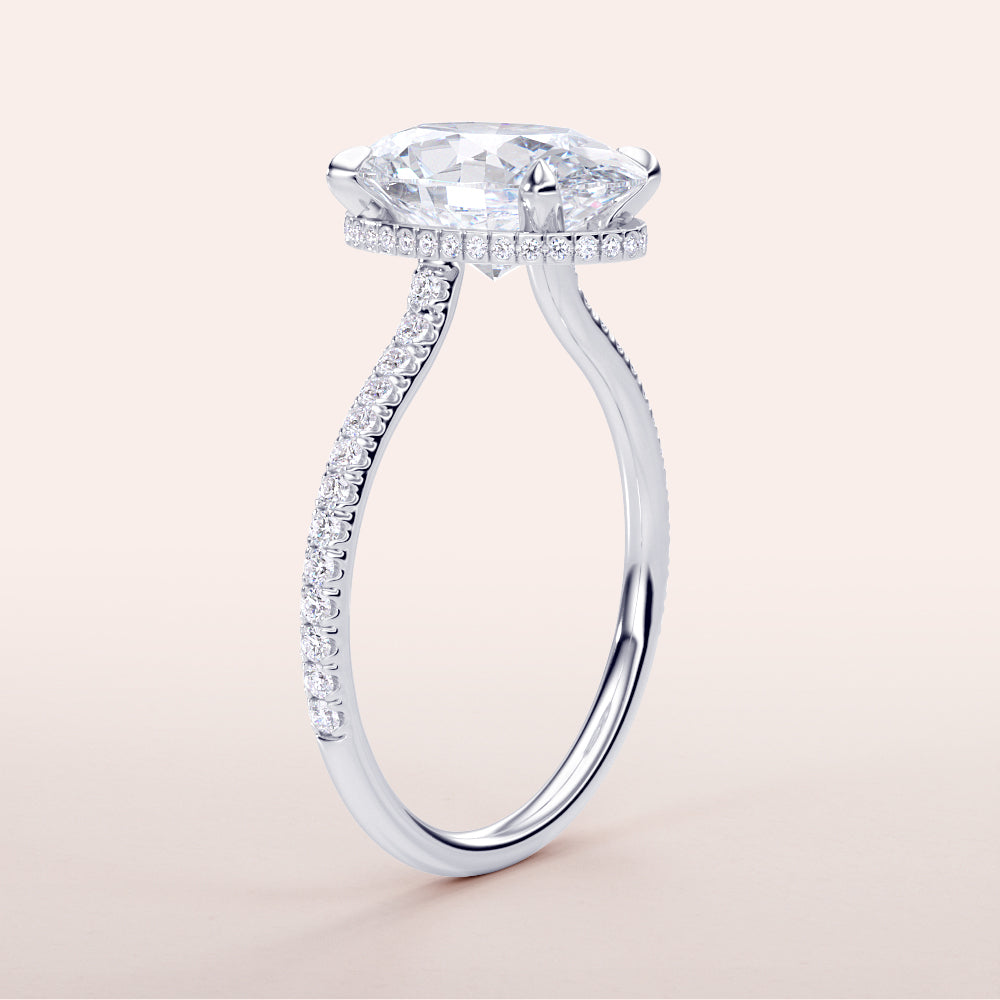 Elegant oval engagement ring in white gold, featuring a hidden halo and pave band, available in 14K and 18K options.
