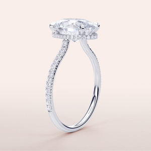 Elegant oval engagement ring in white gold, featuring a hidden halo and pave band, available in 14K and 18K options.