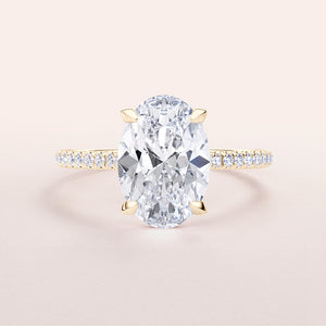 Elegant 14K yellow gold engagement ring with oval-cut diamond center and pave band, perfect for special moments.