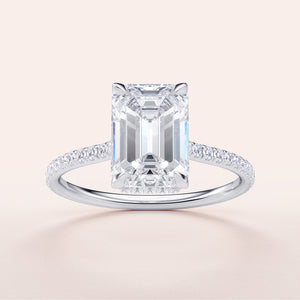 Emerald-cut diamond ring with shimmeringPave band in 14K, 18K gold or platinum settings, perfect for engagement.