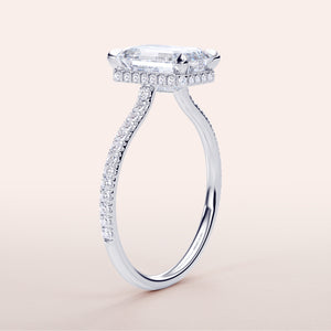 Elegant 14K white gold engagement ring with emerald, invisible gallery, hidden halo, and pave diamond band. Timeless luxury.