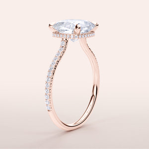 Side view of a 14K rose gold engagement ring with cushion-cut diamond and halo, featuring a pave-set band for added sparkle.