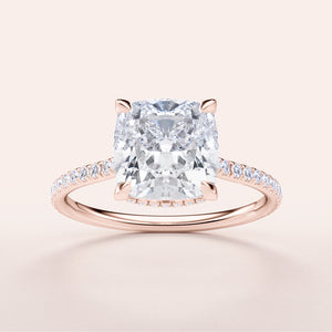 Elegant 14K rose gold engagement ring featuring a cushion-cut diamond and dazzling pave band, perfect for timeless love.