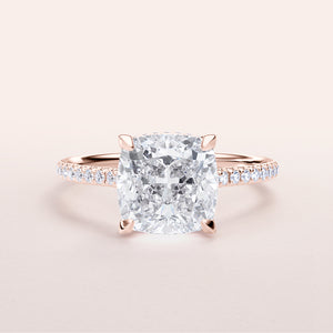 Elegant cushion-cut diamond engagement ring in rose gold, featuring a diamond-accented band, available in 14K or 18K gold or platinum.