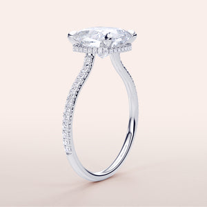 Close-up of a stunning 14K/18K white gold engagement ring with a brilliant marquise-cut diamond and intricatePave-set accents.