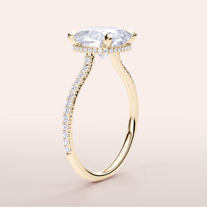 Elegant yellow gold engagement ring in 14K/18K featuring a round diamond and halo design, not worn on model.