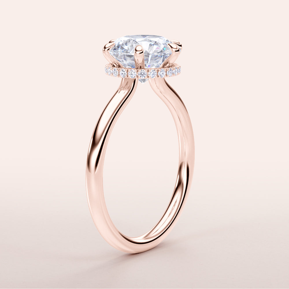 Rose gold solitaire pear-shaped diamond engagement ring with halo, available in 14K/18K rose gold or platinum. Elegant and brilliant design.