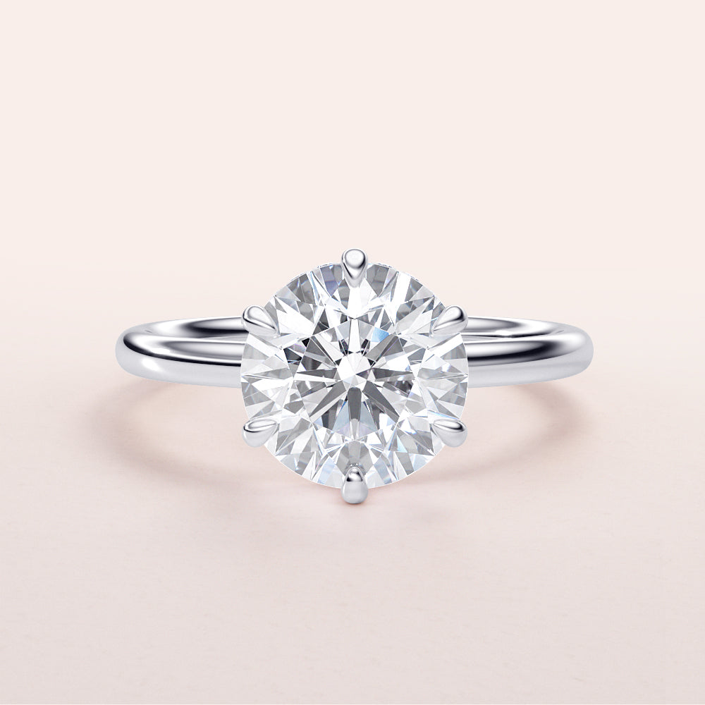 Exquisite round-cut diamond engagement ring in 14K or 18K white gold, featuring a classic prong settingâ€”perfect for proposals.