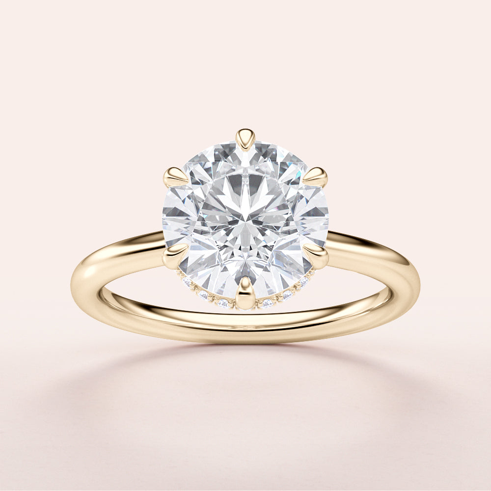Elegant 14K or 18K yellow gold engagement ring featuring a stunning round brilliant diamond with an invisible halo design.