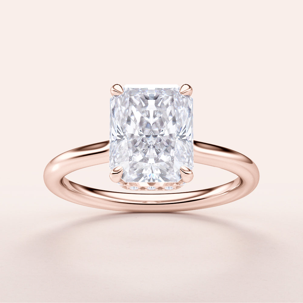 Elegant 14K rose gold engagement ring featuring a stunning radiant-cut diamond in an invisible gallery hidden halo design.