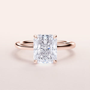 Radiant cut diamond engagement ring in 14K rose gold, showcasing the brilliant gemstone and delicate plain band.