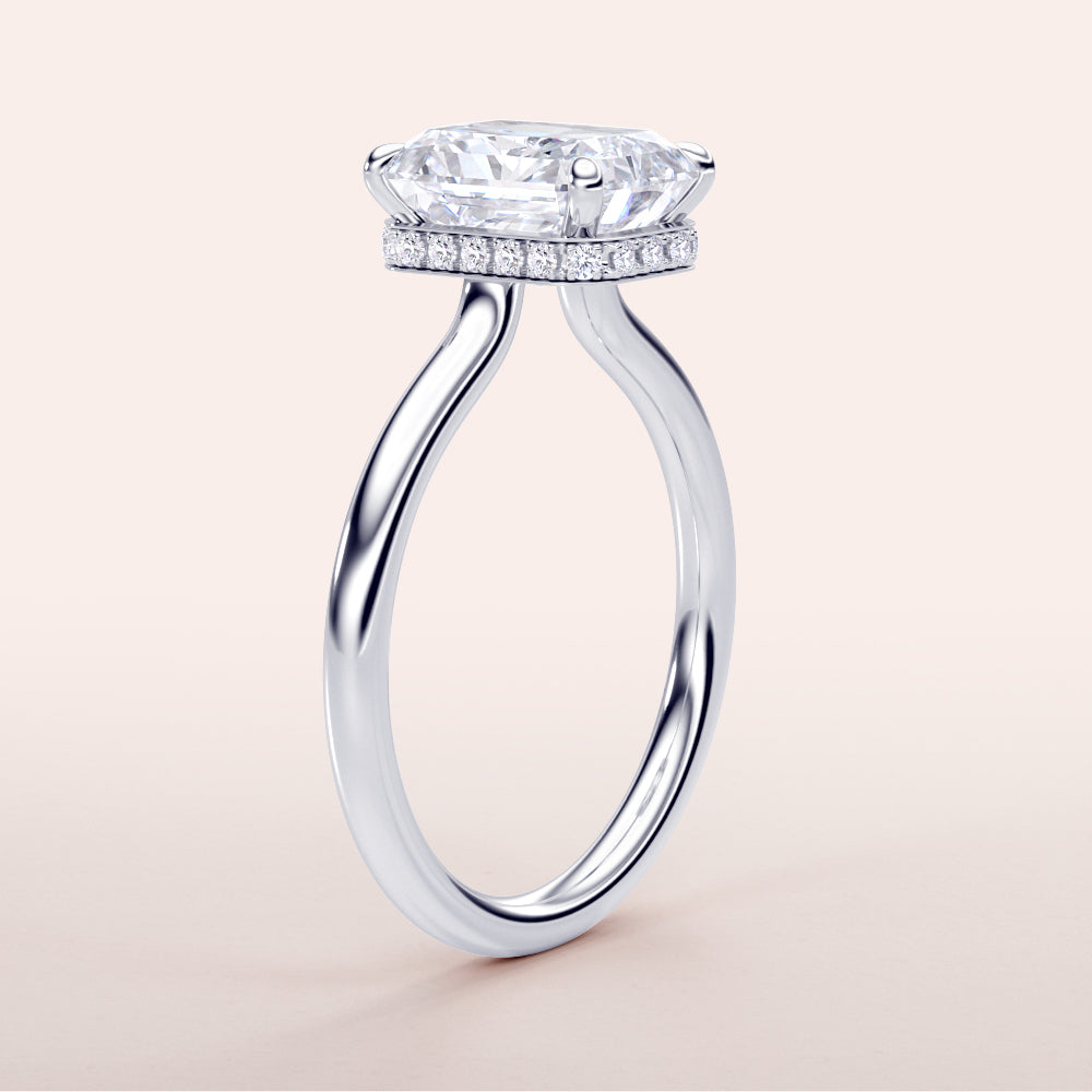 Elegant 14K or 18K white gold engagement ring with radiant cut diamond andPave halo, showcasing intricate details.
