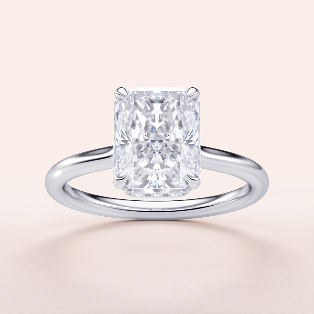 "14K White Gold engagement ring featuring a radiant-cut diamond with an invisible gallery and hidden halo, displayed on a neutral background."