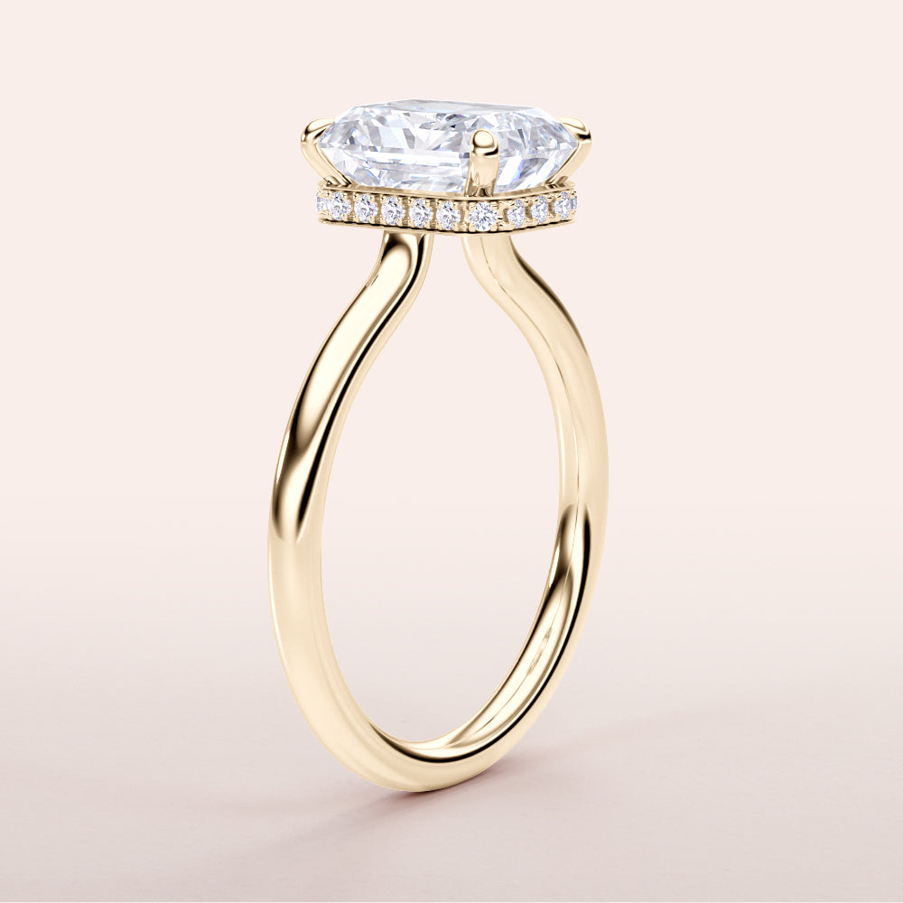 Elegant 14K gold engagement ring featuring an east-west elongated cushion-cut diamond with a hidden halo of smaller diamonds.