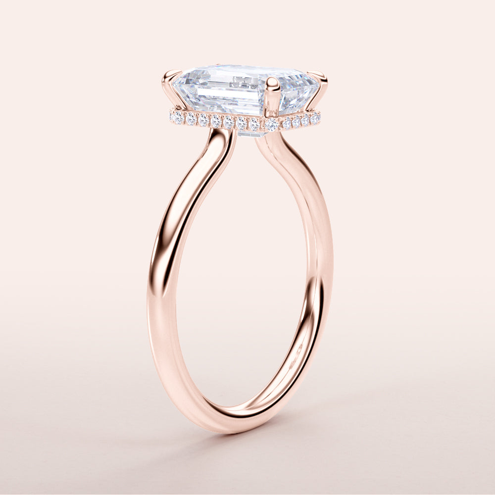 Rose gold engagement ring featuring an elongated shield-shaped diamond and pave accents, available in 14K, 18K, or platinum.