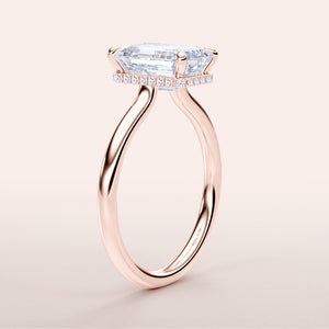 Rose gold engagement ring featuring an elongated shield-shaped diamond and pave accents, available in 14K, 18K, or platinum.