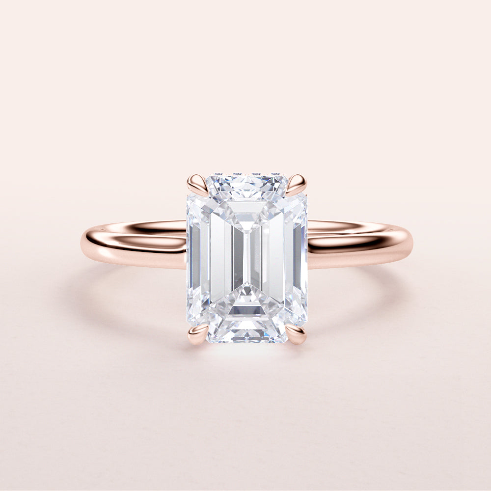 Elegant rose gold emerald engagement ring with hidden halo, available in 14K, 18K, or platinum for a timeless look.