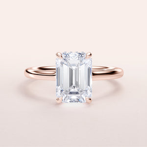 Elegant rose gold emerald engagement ring with hidden halo, available in 14K, 18K, or platinum for a timeless look.