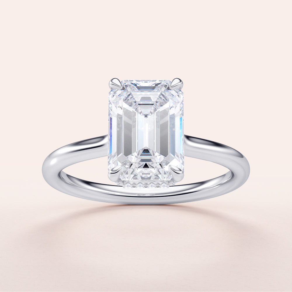 Emerald cut diamond solitaire engagement ring in 14K or 18K gold or platinum with a hidden halo and plain band.
#14KRecycledWhiteGold
#18KRecycledWhiteGold
#Platinum