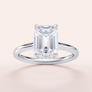 Emerald cut diamond solitaire engagement ring in 14K or 18K gold or platinum with a hidden halo and plain band.
#14KRecycledWhiteGold
#18KRecycledWhiteGold
#Platinum